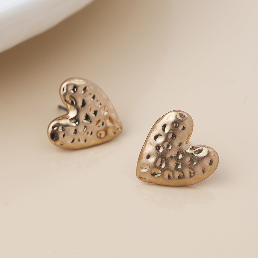 POM Golden worn hammered heart earrings