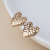 POM Golden worn hammered heart earrings