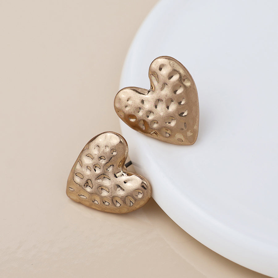POM Golden worn hammered heart earrings